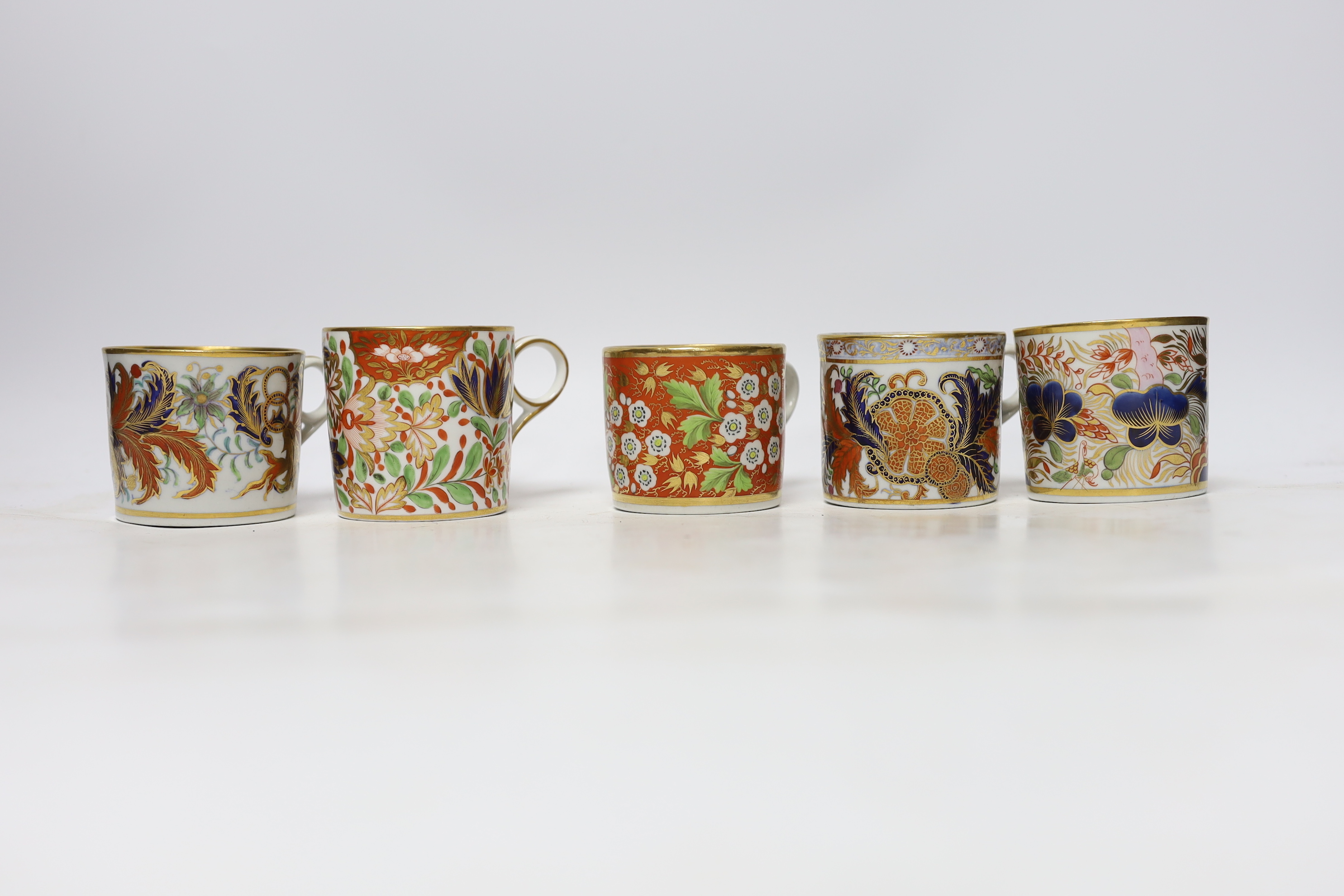 Twelve 1800-1820 English porcelain coffee cans and tea cups, including Imari pattern examples